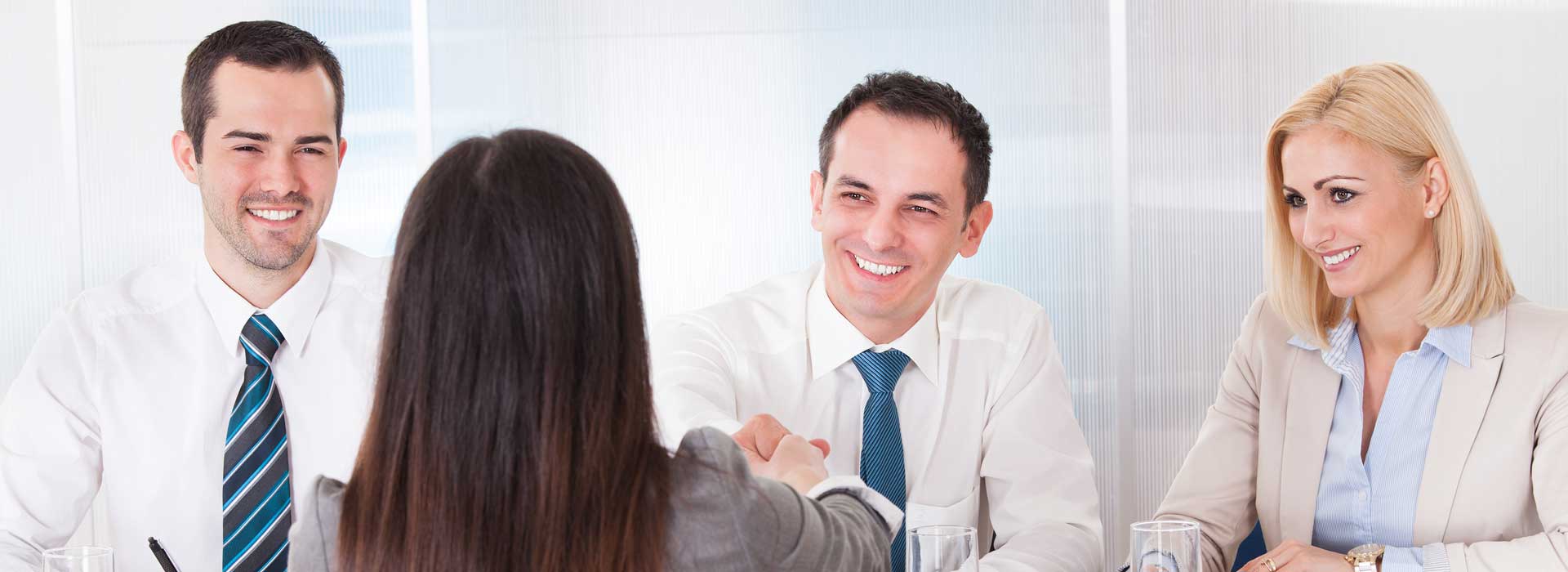 Business people with hands together signifying teamwork